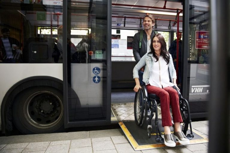 Eine Rollstuhlfahrerin verlässt den Buss über eine ausgeklappte Rampe