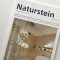 Titel der Zeitschrift Naturstein zeigt eine schwellenloses Dusche mit einer Lichtdurchleuchteten Fläche.